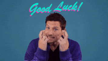 Video gif. A man looks straight at us. He is tensed up as he tightly crosses his fingers in front of his face. He grits his teeth so hard that he’s shaking. Text, “good luck!”