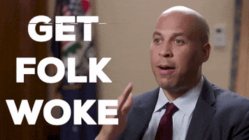 Political gif. Senator Cory Booker, eyes wide with energy, emphasizing with a karate chop gesture, says "get folk woke."