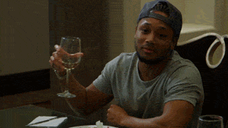 Reality TV gif. Romeo Miller on Growing Up Hip Hop. He's holding a wine glass and opens his arms and shrugs nonchalantly.