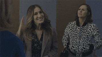 TV gif. Sarah Jessica Parker as Frances on Divorce crosses her fingers and smiles.