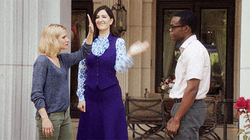 TV gif. Kristen Bell as Eleanor in The Good Place holds up a hand for D'Arcy Carden as Janet to give her an excited high five as William Jackson Harper as Chidi looks on. Flashing text, “*High Five*.”