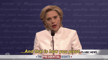 SNL gif. Kate McKinnon as Hilary Clinton during the presidential debates. She adopts a robotic stance as she puts her arms up and moves from right to left stiffly, saying, "And that is how you pivot!"