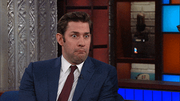TV gif. During a Late Show interview John Krasinski shrugs his shoulders and sticks his tongue out as if he's disgusted. 