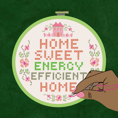 Text gif. Hand stitching a classic needlepoint with a little house and the message "Home sweet energy efficient home" against a lush green background.