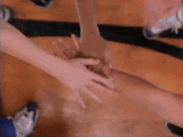 Disney gif. In a scene from Air Bud, several hands go into the center of a basketball huddle, then a dog's paw.