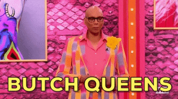Reality TV gif. RuPaul from RuPaul's Drag Race is addresses the contestants and he smiles down at them while saying, "Butch queens."