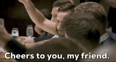 TV gif. Clip of contestants on "The Ultimate Fighter" raising their glasses around a table and saying, "Cheers to you, my friend."