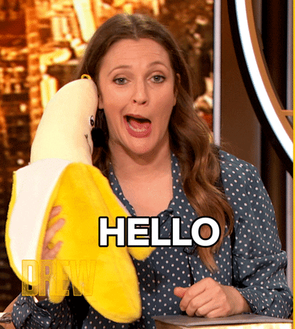 TV gif. Drew Barrymore hosting the Drew Barrymore Show distorts her mouth to the side of her face like she's speaking. She holds a giant banana plushy to her ear. Text, "Hello." 