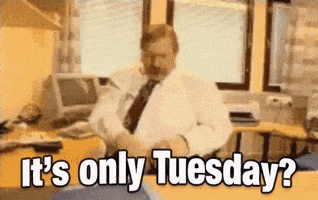 Video gif. A blurry video shows a man in a cubicle sitting in front of a 90s-style computer throwing his papers all around the room in disgust. Text, "It's only Tuesday?"