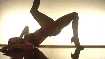 Music video gif. Wearing sharp stilettos and skimpy lingerie, Jennifer Lopez lies on the floor, with her pelvis elevated, pulling one leg toward her face and using the other to prop herself up.
