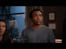 TV gif. We zoom in on Donald Glover as Troy in Community as he stares with bug eyes and says, "I knew it!"