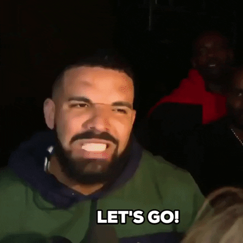 Video gif. Actor and rapper Drake screams "Let's go!" in a crowd of people and photographers.