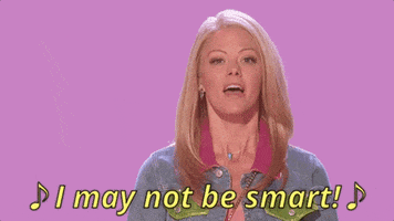 Celebrity gif. Kate Rockwell as Karen Smith in the Broadway adaptation of Mean Girls performs at the Tony Awards in 2018. She stands in front of a pink background and is wearing a jean jacket while she belts out, "I may not be smart!"