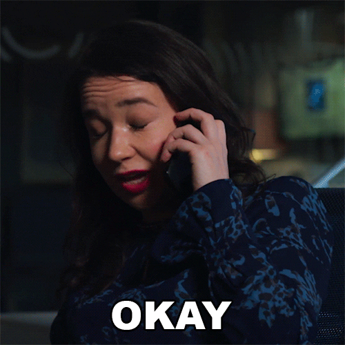 TV gif. Sarah Steele as Marissa Gold in The Good Fight holds a cell phone to her ear, shaking her head and closing her eyes while saying, "Okay," with a pained smile.