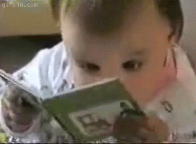 Gif of a baby staring intently at a picture book