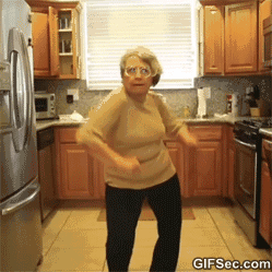 Video gif. An older lady eagerly dances, attempting to copy something she's seen but ends up looking like a chicken dance. Two more friends pop up and the 3 of them do the dance together, rolling their hips and waving their hands in the air, having a grand time.