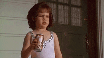 Movie gif. Wearing a sequined ballet outfit, a surprised Brittany Ashton Holmes as Darla from The Little Rascals turns angry and crushes a soda can.
