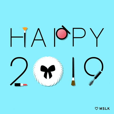 Text gif. Various beauty products like makeup brushes and tubes of lipstick spell out "Happy 2019."