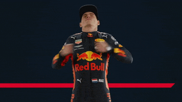 Video gif. Racing driver Max Verstappen closes his eyes and tilts his head back as he beats his chest.