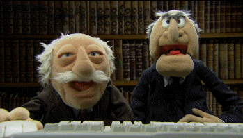 Muppets gif. Statler and Waldorf sit behind a computer desk in a book-lined room and crack up laughing.