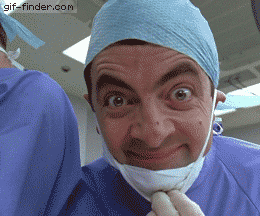 TV gif. We look up at Rowan Atkinson as Mr. Bean wearing medical scrubs. He pulls down a surgical mask, gives a gloved thumbs up, and smiles maniacally.