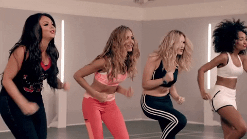 Video gif. Four women in athletic gear enthusiastically run in place while laughing and smiling. 
