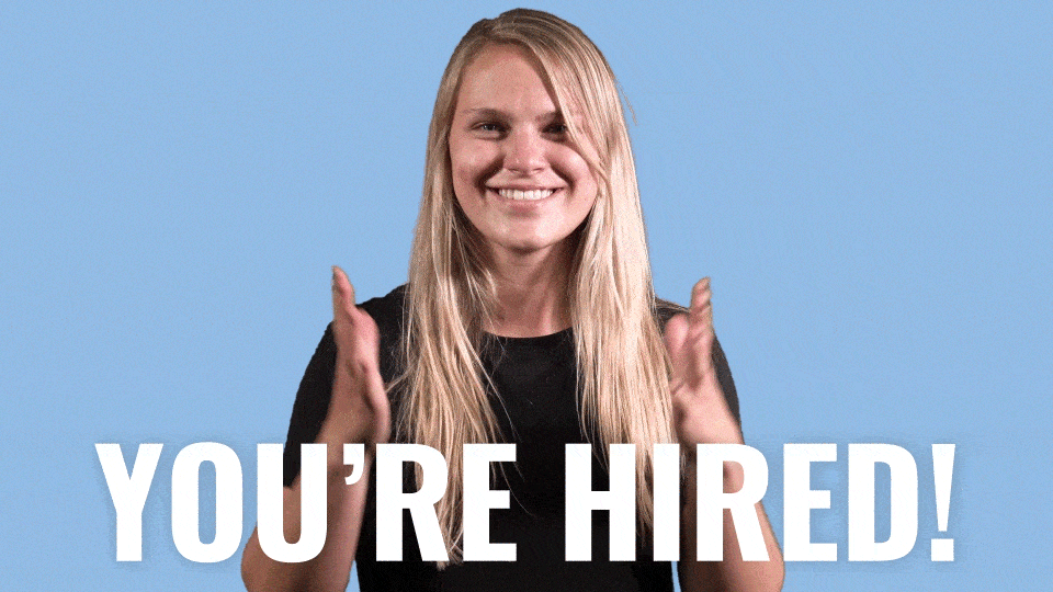A lady opening her arms with the caption "you're hired"