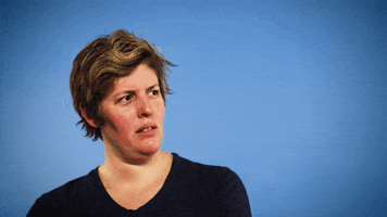 Celebrity gif. Sally Kohn turns her head to look at us with suspicion, squinting.