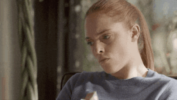 TV gif. Mélanie Robert as Manon in Un Si Grand Soleil crossed her arms as she looks to the side as if angry. 