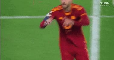 Sports gif. Lorenzo Pellegrini of AS Roma on the soccer field holds his hands up in the shape of a heart then points at someone in the distance with a sincere and confident expression on his face. 