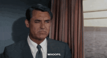 Movie gif. Carey Grant as Roger Thornhill in North by Northwest sits straight-faced in a moving train and blankly says, "Whoops," which appears as text.