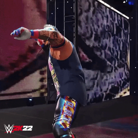 Video game gif. Animated version of wrestler Rey Mysterio raises his fist in a lit-up arena. Text, "let's go."