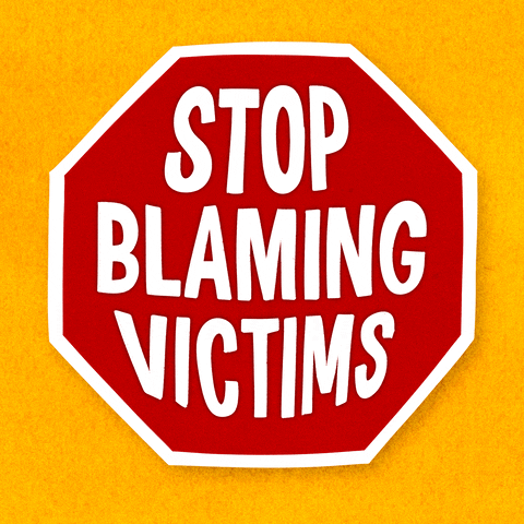 Text gif. Red and white stop sign against a gold background reads, “Stop blaming victims.”