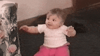 Funny baby excited about being presented with ice cream cone