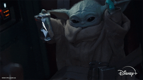 baby yoda waving his hands in the air