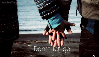 couple holding hands GIF