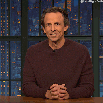 Late Night gif. Seth Meyers licks the tip of his pointer finger and holds it out as if what he touched would sizzle.