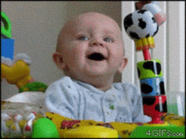 Video gif. A baby sits in a walker with toys all over it. It laughs at something off screen, and then suddenly looks absolutely terrified, flailing its arms as its eyes and mouth widen. After a moment the baby recovers and starts laughing and smiling again.