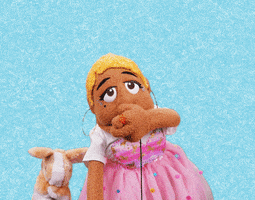 Video gif. A black female puppet in a pink dress blows us a kiss, and a tiny rabbit puppet waves its arms at us. Text, "Mwahh."