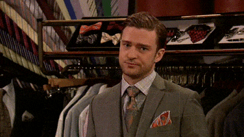Tonight Show gif. Justin Timberlake is doing a sketch on the show and he's in a department store staring at us with an annoyed expression. The camera slowly pans in on him and he holds up two mannequin hands.