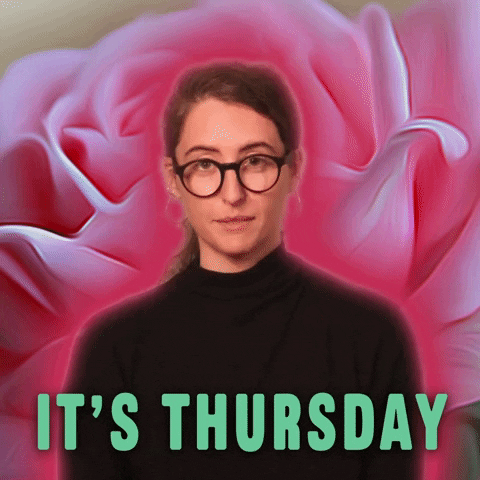 Video gif. Against a pink rose background, a woman wearing glasses and a black shirt plainly tells us: Text, "It's Thursday."