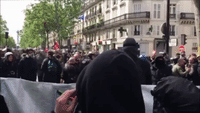 Protesters Push Flaming Cart Towards Police During May Day Clashes in Paris