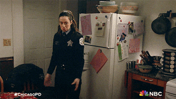 TV gif. Marina Squerciati as Kim in Chicago PD shrugs her shoulders, purses her lips and raises her hands as if to say, “I don’t know.” while standing in a kitchen. 