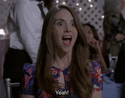 TV gif. Allison Brie as Annie on Community. She's ecstatic and her eyes and mouth go wide as she eagerly leans forward and says, "Yeah!"