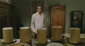 Gif from the movie "Bruce Almighty" showing actor Jim Carrey lighting several candles at once