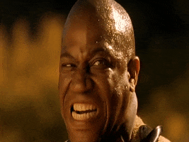 Celebrity gif. Tommy Lister Jr in the music video for Sublime's "Santeria" gritting his teeth and shaking with rage.