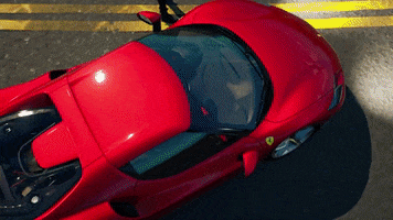 Video game gif. A Ferrari in Fortnite is being shown off as the camera pans on different angles of the racecar.