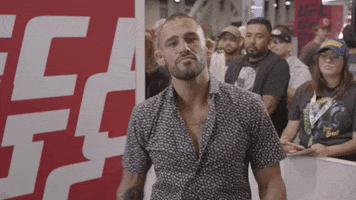 Celebrity gif. Santiago Ponzinibbio holds his arms out and gives two thumbs down, then gestures a slicing motion across his neck.