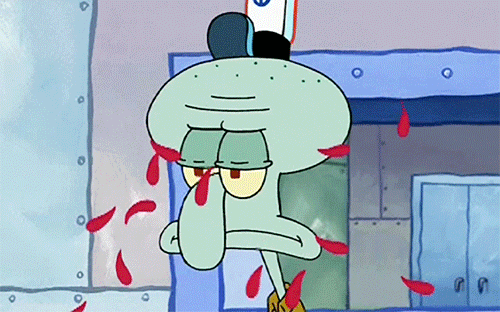 A GIF of Squidward looking annoyed while flower petals are thrown in his face.
