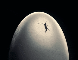 Video gif. A crack appears in the side of an egg and a woman's hand with long claw-like nail pops out. 